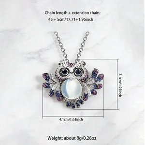 Detail showing colorful owl pendant size with moonstone and rhinestone inlay on silver chain