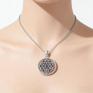 Detailed view of mandala lotus pendant with colorful gems on model neckline