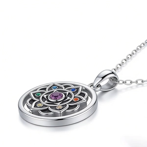 Detail view of silver lotus pendant with purple gem and colorful mandala chakra stones