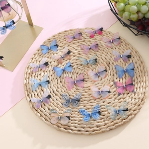 Detail of 20pcs colorful double-layer tulle butterfly hair clips with rhinestones on straw mat