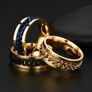 Three stackable titanium steel spinner rings with cuban chain inlay in gold, blue and black