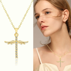 Gold angel wing cross necklace with sparkling crystals and a fine clavicle chain for women