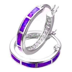 Close-up of silver hoop earrings with purple opal inlay and pavé zircon detailing