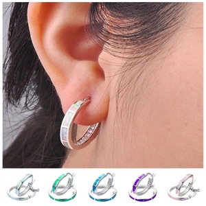 Detail of round hoop earrings featuring multi-color opal stones and small zircon accents