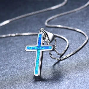 Modern silver cross pendant necklace with blue opal stones on a sleek box chain