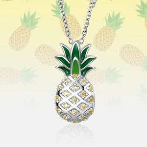 Sparkling silver pineapple pendant necklace with yellow crystals and green enamel leaf