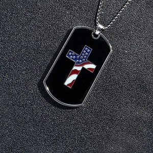 Detailed close-up of American flag cross inlay on black military dog tag pendant