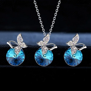 Detail of silver butterfly jewelry set with sea blue crystals and fine white micro-diamonds