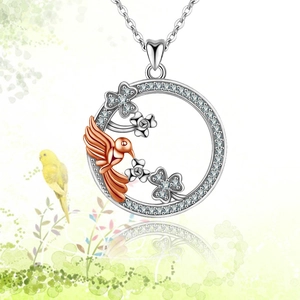 Detail of a bird and clover pendant necklace with micro-pave crystals and polished finish
