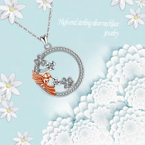 Sterling silver hummingbird and four-leaf clover pendant necklace with rose gold accents