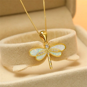 Elegant gold dragonfly pendant necklace with white opal stone and sparkling diamonds