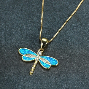 Detailed macro view of dragonfly pendant with blue opal wings and shimmering zircons