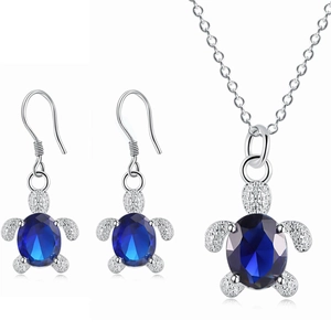 Silver turtle jewelry set with dark blue crystals including necklace and drop earrings