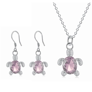 Detailed view of turtle jewelry set featuring pink crystal stones and silver textures