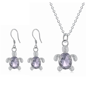 Detailed macro view of turtle jewelry set featuring oval purple crystal and silver metal