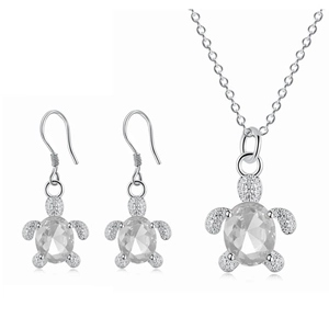 Macro detail of silver turtle jewelry set with faceted clear crystals and pavé accents