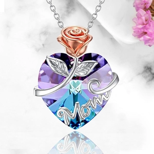 Heart crystal necklace with rose gold flower and Mom charm on marble backdrop