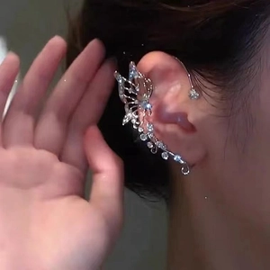 Elegant butterfly ear cuff with silver plating and sparkling rhinestones on female ear