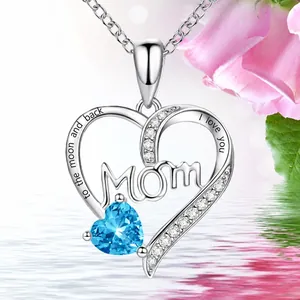 Close-up of heart necklace with Mom lettering and engraved love message on the side