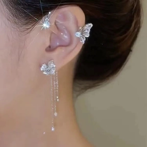 Detail of silver butterfly ear cuff set with tassel chains and shimmering cubic zirconia