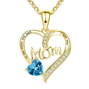 Close-up of gold heart necklace with blue gemstone and I love you engraving