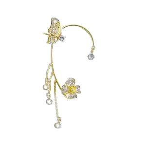 Close-up of golden butterfly ear cuff with tassels and sparkling cubic zirconia details
