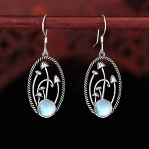 S925 silver vintage mushroom earrings with moonstone on a rustic wooden background