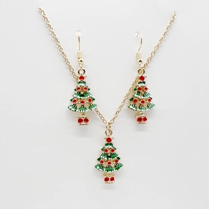 Detail of Christmas tree jewelry set with green and white enamel on golden necklace and earrings