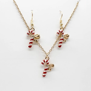 Detail of candy cane jewelry set with red and white enamel and golden bow design