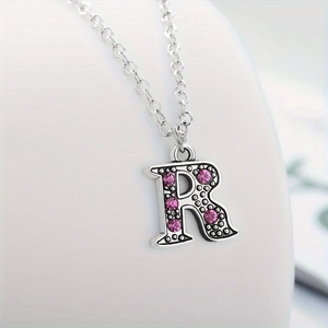 Vintage letter R necklace with pink rhinestones and silver-toned pendant detail