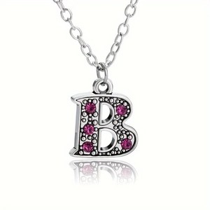 Silver letter B pendant necklace with pink rhinestones and vintage beadwork detail