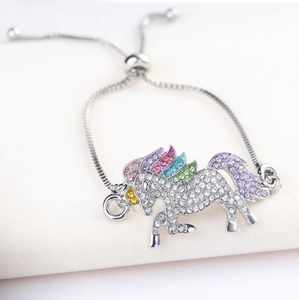 Detailed shot of an adjustable unicorn bracelet with colorful rhinestones on a silver chain