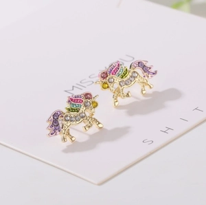 Detailed close-up of unicorn stud earrings with colorful crystals and gold plating