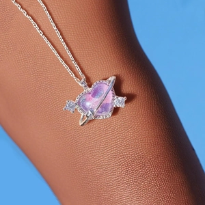 Elegant purple heart planet necklace with silver chain and crystal accents on wrist