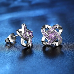 Silver flower stud earrings with purple zircons and twisted petal design in 45-degree view