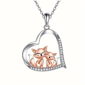 Detailed view of fox mother and child pendant in heart frame with zircon accents