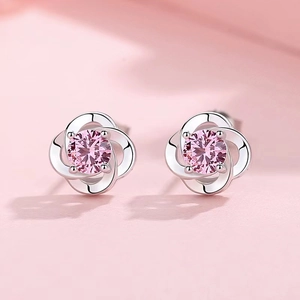 Elegant silver clover stud earrings featuring round-cut pink gemstones in minimalist style