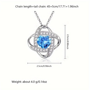 Detailed view of silver heart pendant with blue gemstone and dimension measurements