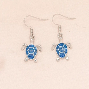 Blue fire opal turtle drop earrings with silver plating for women on pink background