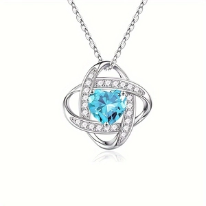 Elegant heart necklace with light blue gemstone and shimmering cubic zirconia accents
