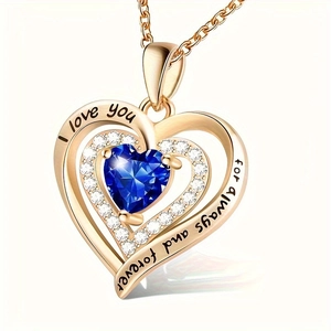 Detail of rose gold heart pendant featuring blue gemstone and romantic engraving