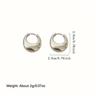 Detailed view of silver geometric huggie earrings with a 2.0cm diameter measurement