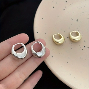 Minimalist teardrop geometric metal earrings in silver and gold with high-polish finish