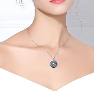 Elegant silver turtle pendant necklace with colorful abalone shell on a female model