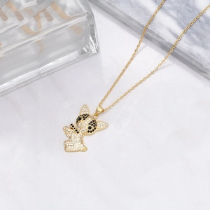 Chic gold-plated dog pendant necklace with sparkling pavé zircon stones on white background