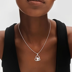 Silver necklace with cute hollow heart and cat silhouette pendant on a model