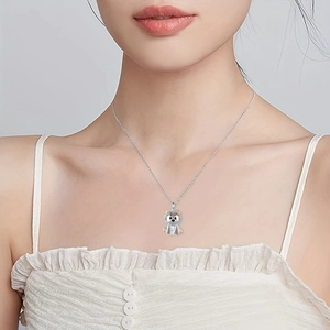 Cute silver lion pendant necklace with colorful flower details worn by a female model