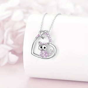 Detailed close-up of a heart-shaped cat pendant necklace with pink and white crystals