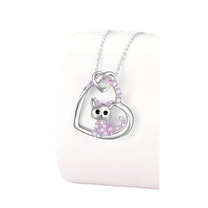 Delicate silver heart necklace with a pink crystal cat pendant on a white jewelry stand