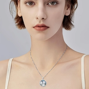 Elegant silver turtle pendant necklace with blue marble inlay shown on a model neck